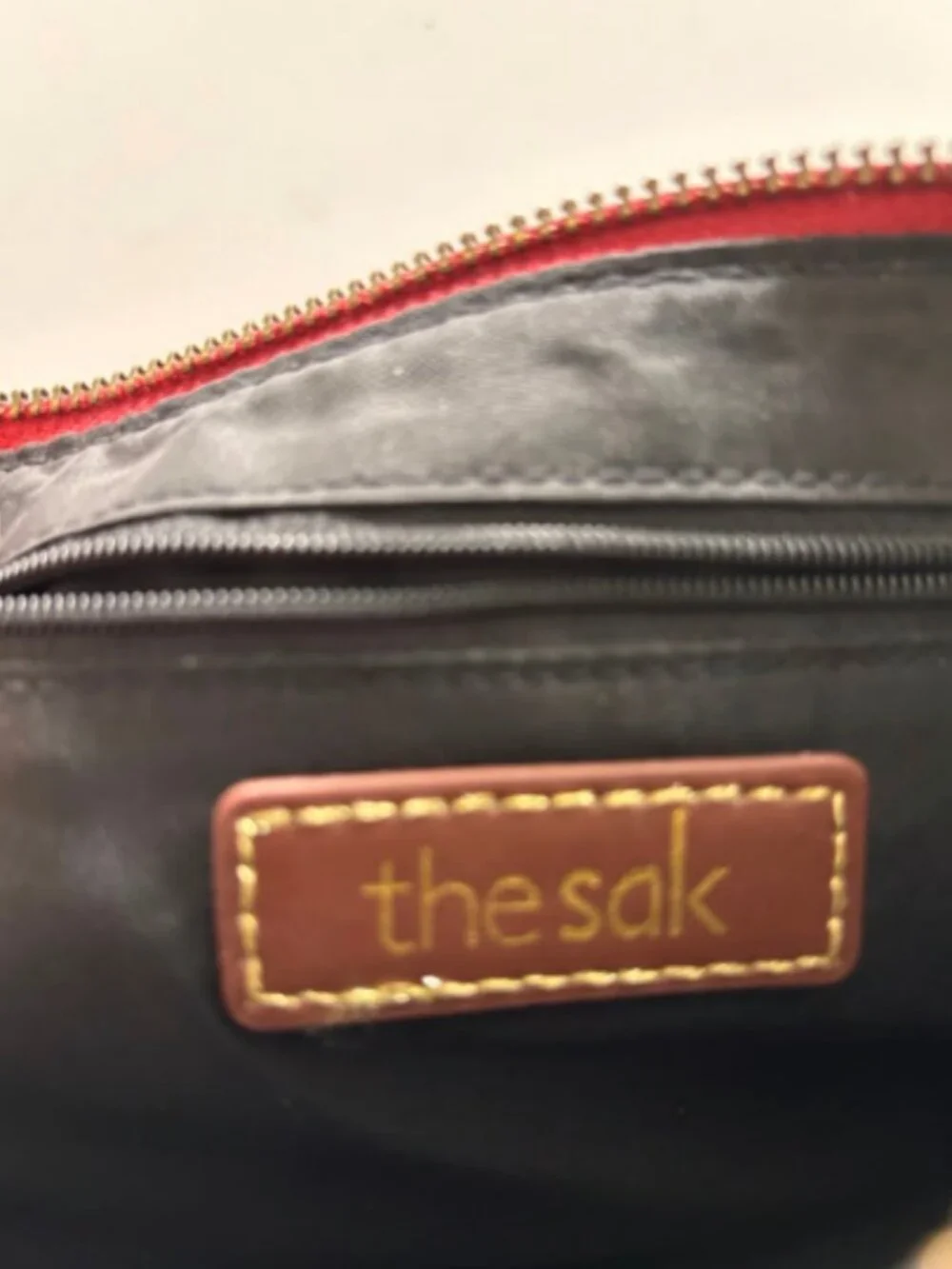 The Sak Red Pebbled Leather Crossbody Bag with Bag Charm & Front Zip Pocket